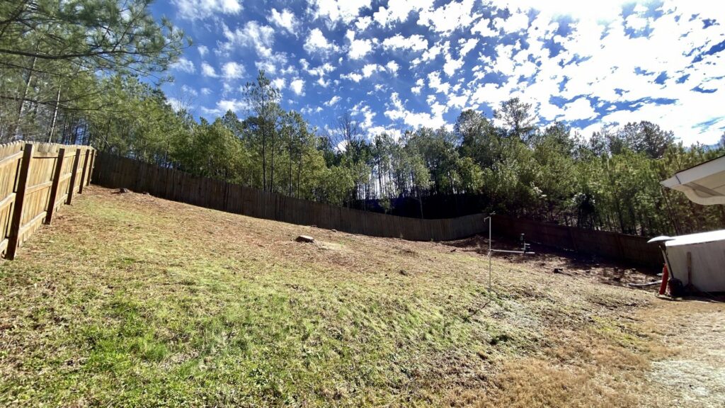 A residential backyard showing a recently removed tree stump, highlighting tree removal services by Log and Leaf Tree Service in Hoover, AL.