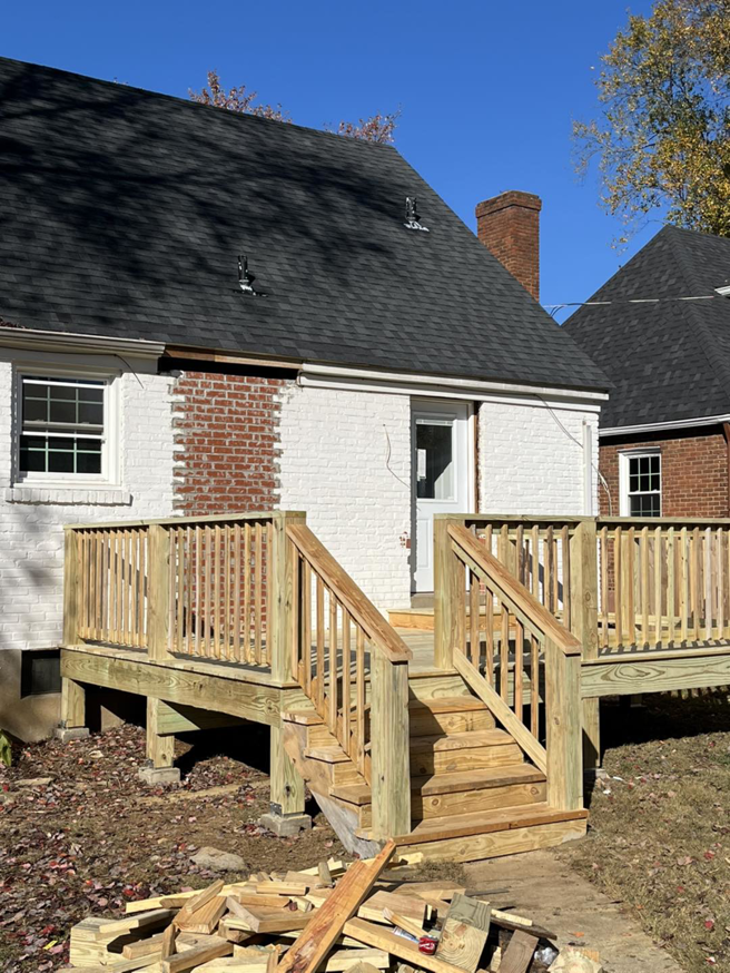 A backyard wooden deck with stairs under construction by Brother George Remodeling & Construction in Louisville, KY.