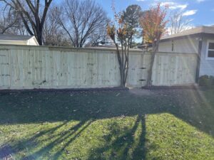 A newly installed wooden privacy fence in a backyard, completed by Brewer Builds in Fort Worth, TX.