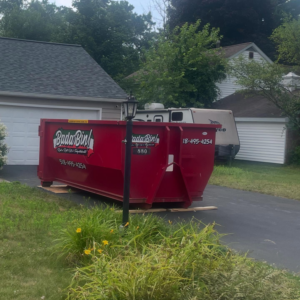 A Bada Bin roll-off dumpster placed on a residential driveway for a general cleanup in Schenectady, NY.
