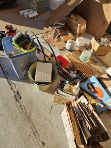 Bagged yard waste and a pile of branches on a tarp, prepared for junk removal by We R Trash Inc. in Loveland, CO