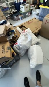Bags of trash and cardboard boxes on a floor, indicating items ready for junk removal by Route Junk in Orlando, FL.