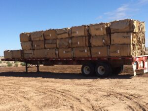 Baled cardboard boxes stacked on a flatbed trailer for recycling or waste transport by A Track-Out Solution in Las Vegas, NV.
