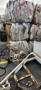 Stacks of baled plastic waste and processing equipment at RENUOil Of America, INC in Las Vegas, NV