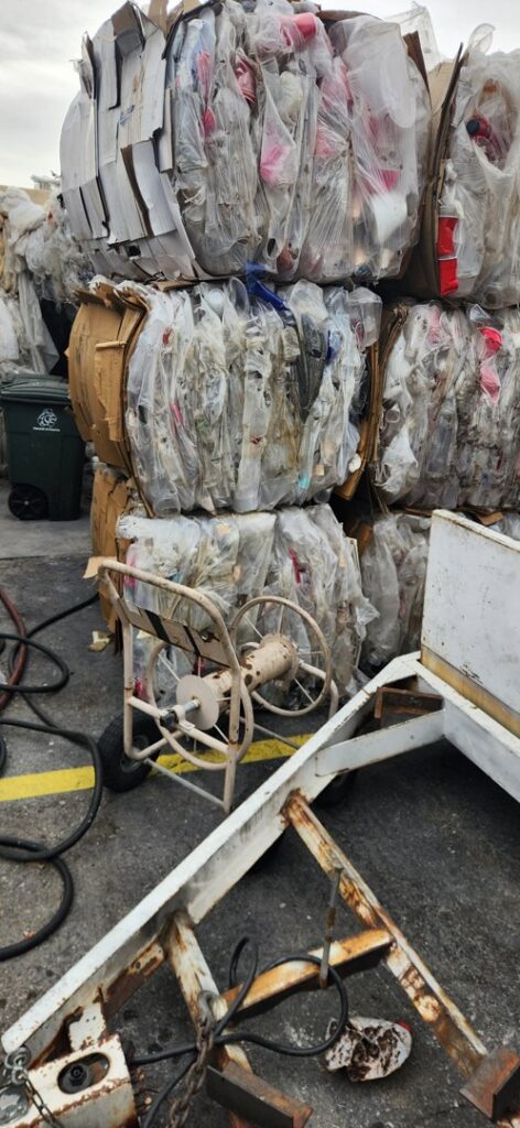 Stacks of baled plastic waste and processing equipment at RENUOil Of America, INC in Las Vegas, NV