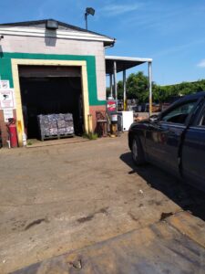 Baled scrap metal visible inside the recycling facility at CycleMET inc. in Columbus, OH, with a car parked outside.