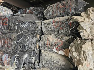 Large bales of compressed scrap metal and plastic ready for recycling at Nevada Recycling and Salvage in Reno, NV.