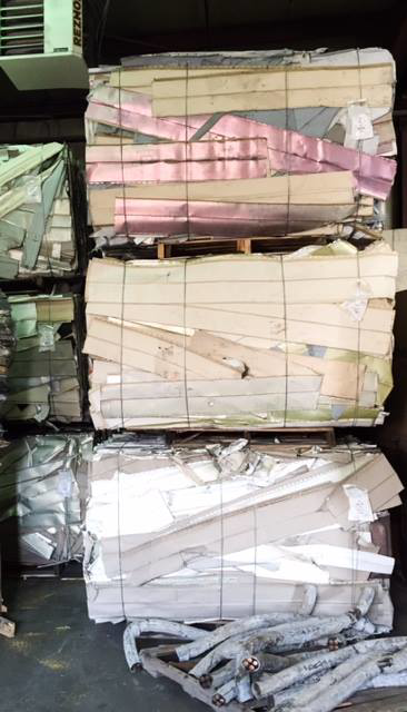 Bales of compressed cardboard and metal scraps ready for recycling at Get Green Recycling Co. in Aurora, IL.