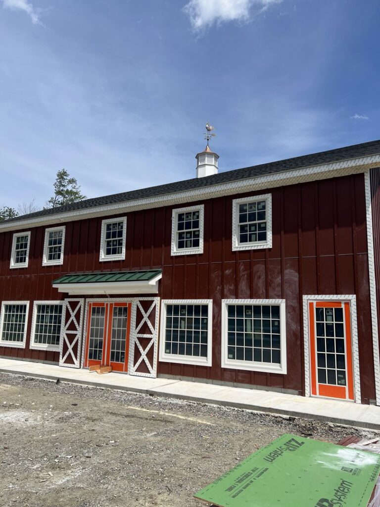 Newly constructed barn-style building exterior with windows and doors by LCM FRAMING LLC in Danbury, CT