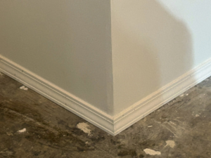 Close-up of new baseboard trim installed during a renovation by Pinnacle Roofing & Construction LLC in Elkhart, IN.