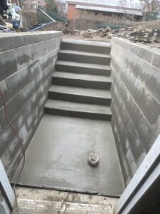 New concrete steps leading to a basement access area by Mudd Brothers Contracting Co. in Pittsburgh, PA.