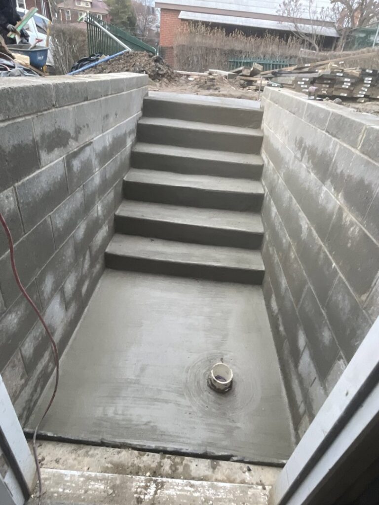 New concrete steps leading to a basement access area by Mudd Brothers Contracting Co. in Pittsburgh, PA.