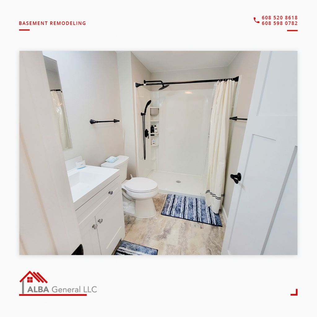 A newly remodeled basement bathroom featuring a shower, toilet, and vanity by Alba General in Madison, WI.
