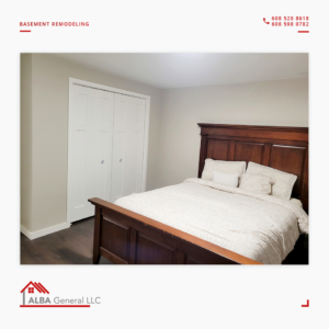 A comfortable, newly remodeled basement bedroom with a wooden bed and white closet doors by Alba General in Madison, WI.