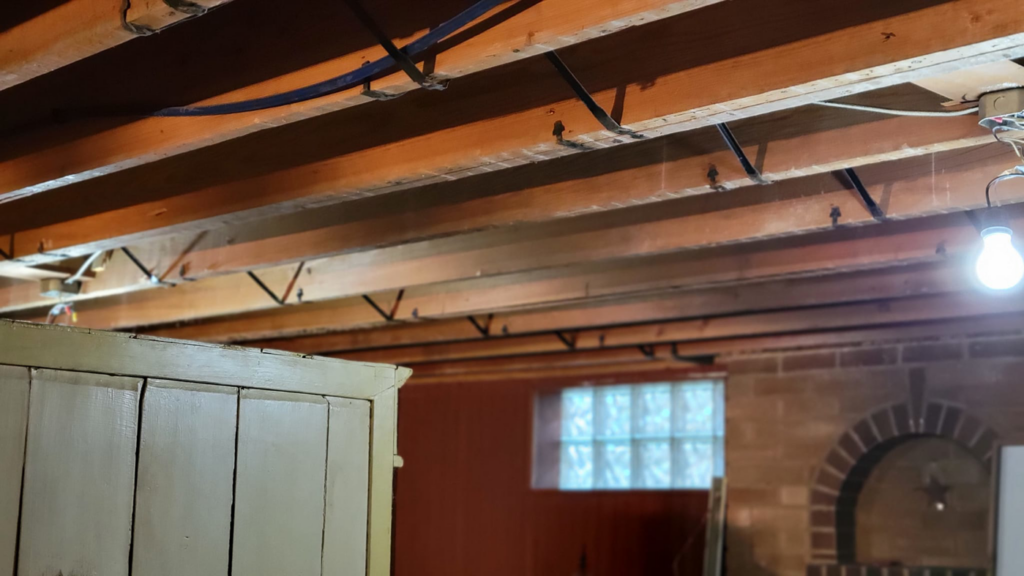 Basement ceiling renovation showing exposed joists and wiring by M&M Drywall and Construction in Enid, OK