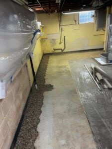 Installation of a basement drainage system with gravel trench by ARK Basement Services - Erie, PA