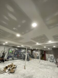 Basement interior with new drywall and recessed lighting installed by Sanchez & Hall Construction in Richmond, VA.