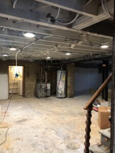Basement under construction showing electrical rough-in and appliance installation by AES Electrical Contractor in Richmond, VA.
