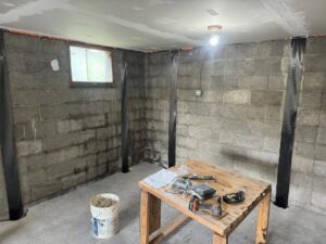 Basement foundation repair with carbon fiber straps on block walls by ARK Basement Services - Erie, PA