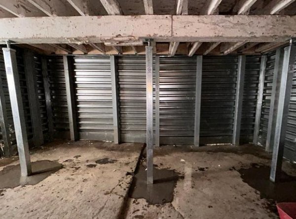 Basement foundation repair with metal support beams and wall panels installed by Woodford Bros., Inc. in Apulia Station, NY