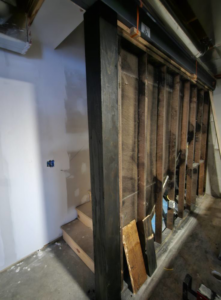 Basement framing and stained beam installation in progress by This and That Handyman and Home Wellness in Olathe, KS.