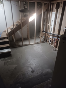 Interior basement framing and a freshly poured concrete floor during a remodeling project by RS handyman llc in Kenai, AK.