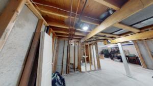 Interior framing and exposed ceiling in a basement under construction, managed by M7 Remodel & Restoration Inc. in Houston, TX