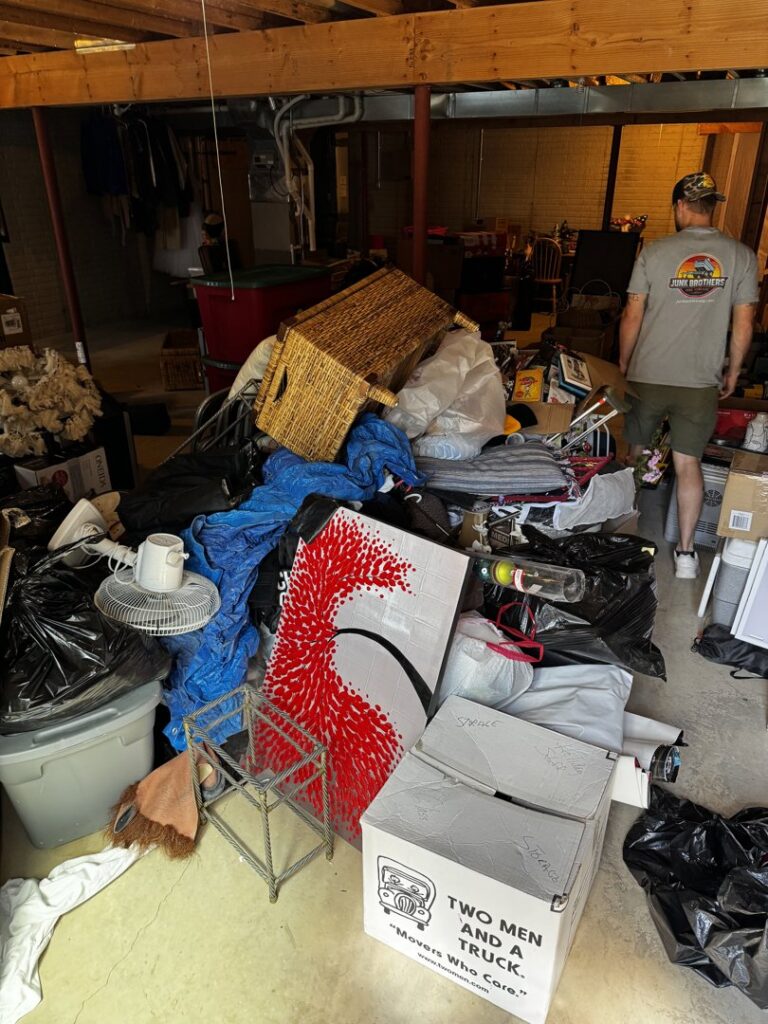A cluttered basement filled with a large pile of junk ready for removal by Junk Brothers in Louisa, KY.