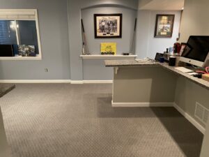 A finished basement living area with a built-in shelf and bar, showcasing renovation work by RAW Renovation in Denver, CO.