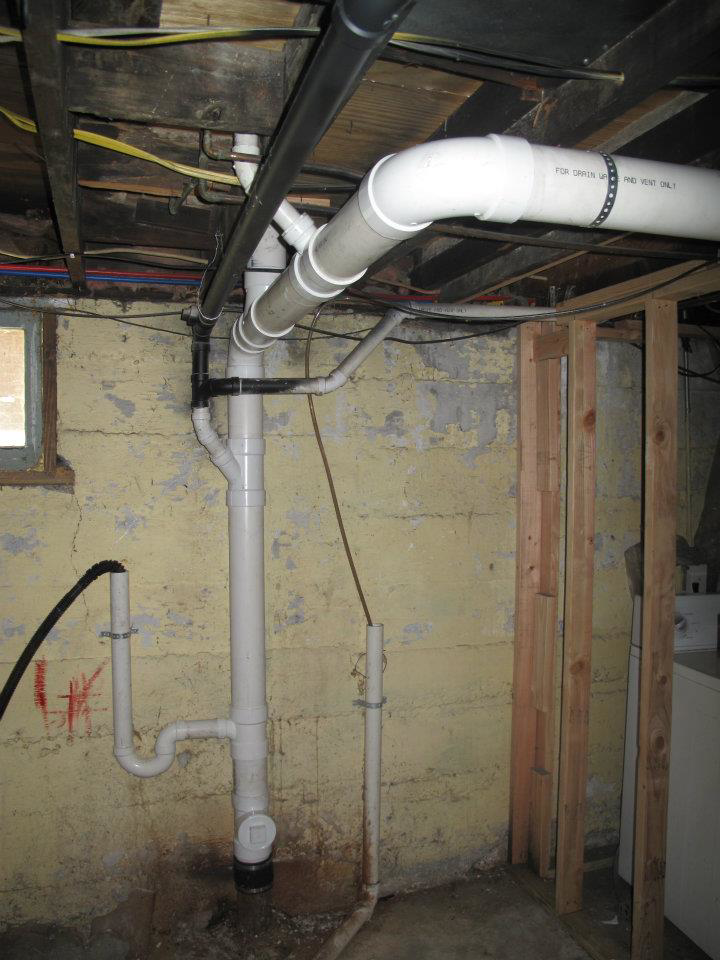 Basement showing new plumbing pipe installation and repair work by Kingdom Advance Construction in Louisville, KY