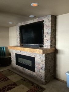 A remodeled basement room featuring new ceiling tiles and recessed lighting by ROTH WORX LLC in Bismarck, ND.