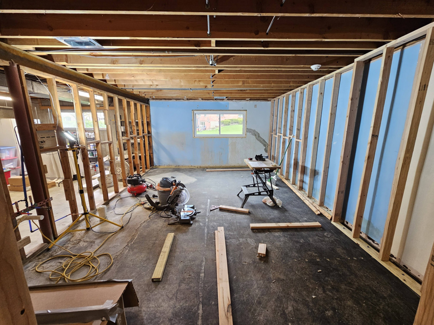 Basement remodeling in progress with new wall framing and construction tools by AIS Home Service's in St. Louis, MO.