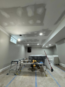 Basement renovation in progress with new drywall ceiling and recessed lighting by Fine Lines Painting & Restoration llc in Buffalo, NY.