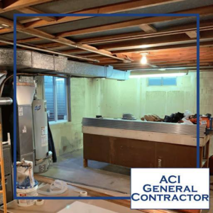 A basement renovation project in progress, showing exposed joists and ductwork by ACI - General Contractor in Montgomery, IL.