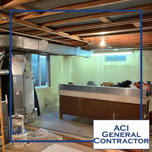 A basement renovation project in progress, showing exposed joists and ductwork by ACI - General Contractor in Montgomery, IL.