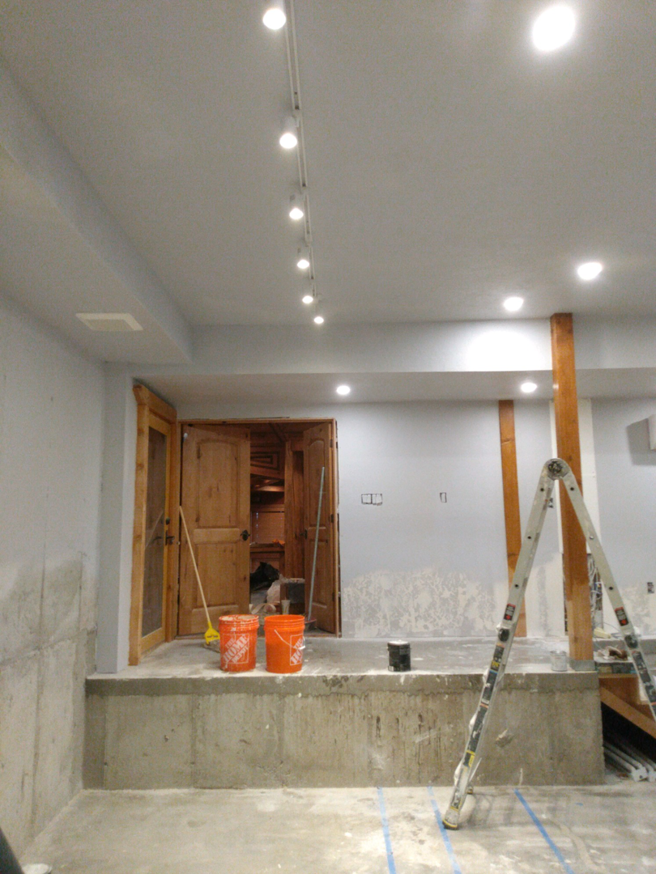 A basement renovation project in progress with new lighting and unfinished walls by J & D Home Innovations in West Jordan, UT