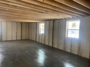 Spray foam insulation applied to basement walls and floor joists in a construction project by Spray Foam Solutions Of Erie in Erie, PA.