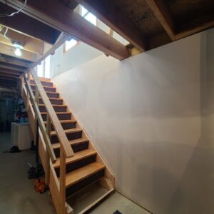 An unfinished basement staircase with new drywall installation by Lincoln Handyman Services in Lincoln, NE