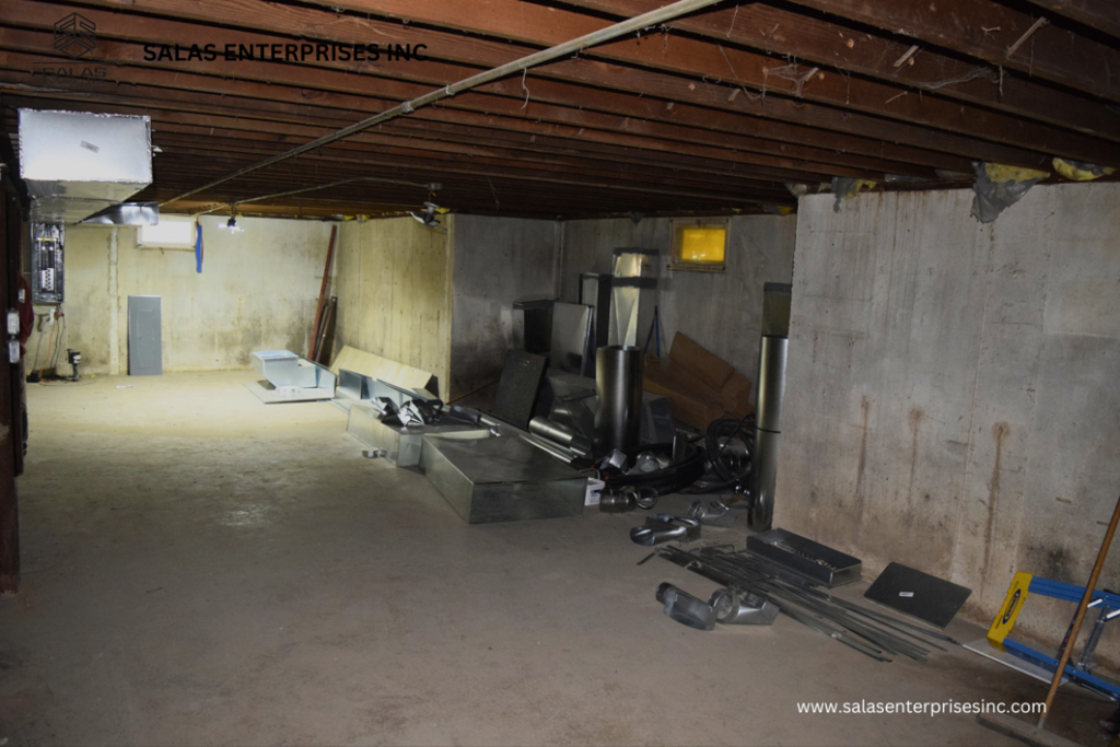 A basement utility area with new ductwork and construction materials ready for installation by Salas Enterprises, Inc in Elgin, IL