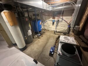 A completed basement utility area with water heaters and pipes, showing waterproofing work by The Basement Doctor in Reynoldsburg, OH.