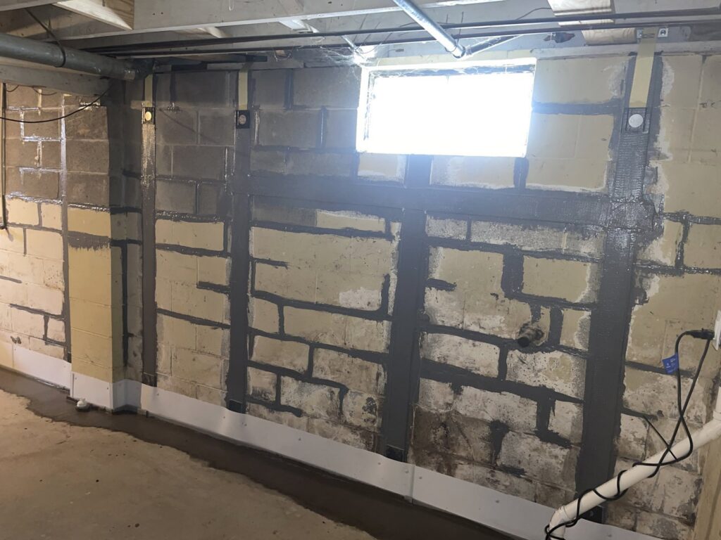 Basement wall reinforced with carbon fiber straps for foundation repair by The Basement Doctor in Reynoldsburg, OH.