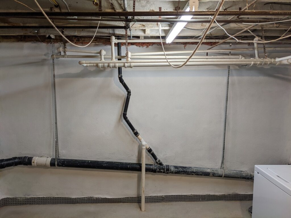 Newly installed basement waterproofing drainage mat and coated wall by Foundation Repair and Waterproofing in Philadelphia, PA.