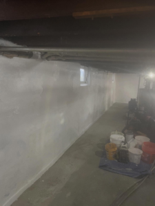 Basement waterproofing and painting project in progress by Calnan Site Development LLC, a handyman in Lynn, MA.