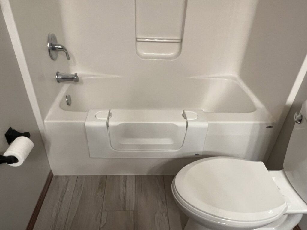 A bathroom featuring a newly installed walk-in tub for improved accessibility by The Sioux Falls Handyman in Sioux Falls, SD.