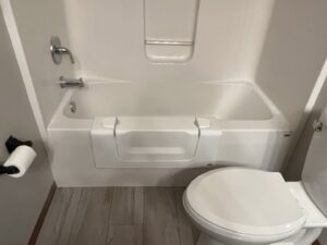 A bathroom featuring a newly installed walk-in tub for improved accessibility by The Sioux Falls Handyman in Sioux Falls, SD.