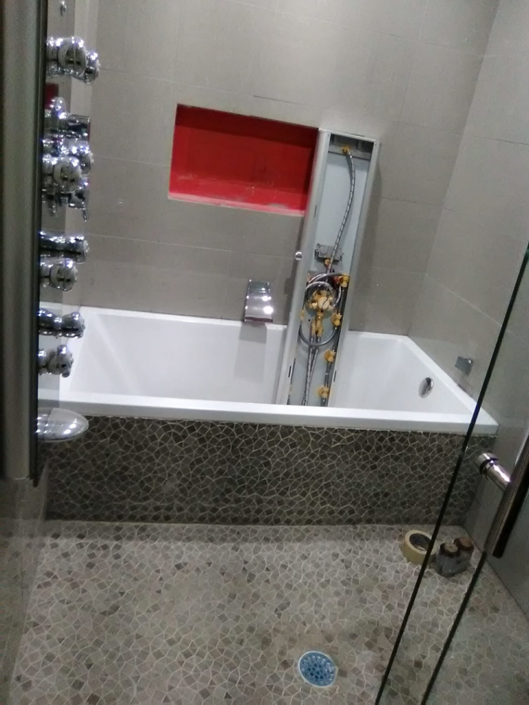 A bathroom renovation showing a new bathtub and shower system installation by Pro Helping Hands Renovation in Colorado Springs, CO.