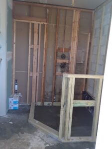 Bathroom under construction with framing and plumbing rough-in by Corley Construction Inc in Fort Lauderdale, FL