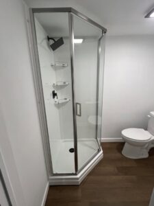 A newly installed corner shower unit in a renovated bathroom by Smitty's Handyman Service LLC in Mesquite, TX.