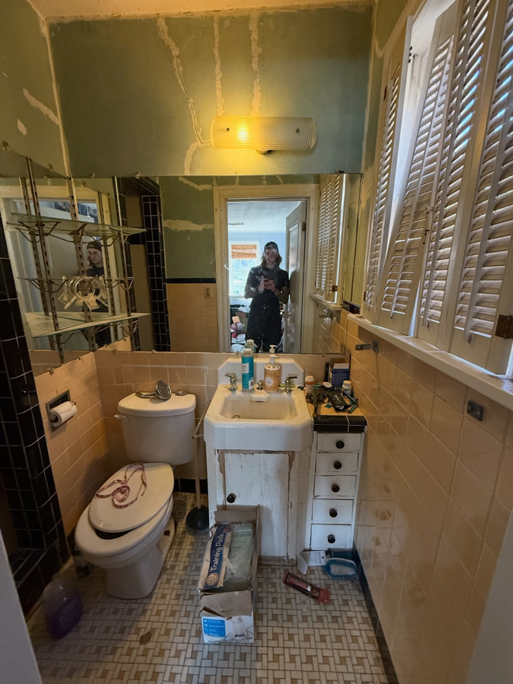 A bathroom before renovation, showing old fixtures and prepped walls, by Waking Up Construction in Oklahoma City, OK