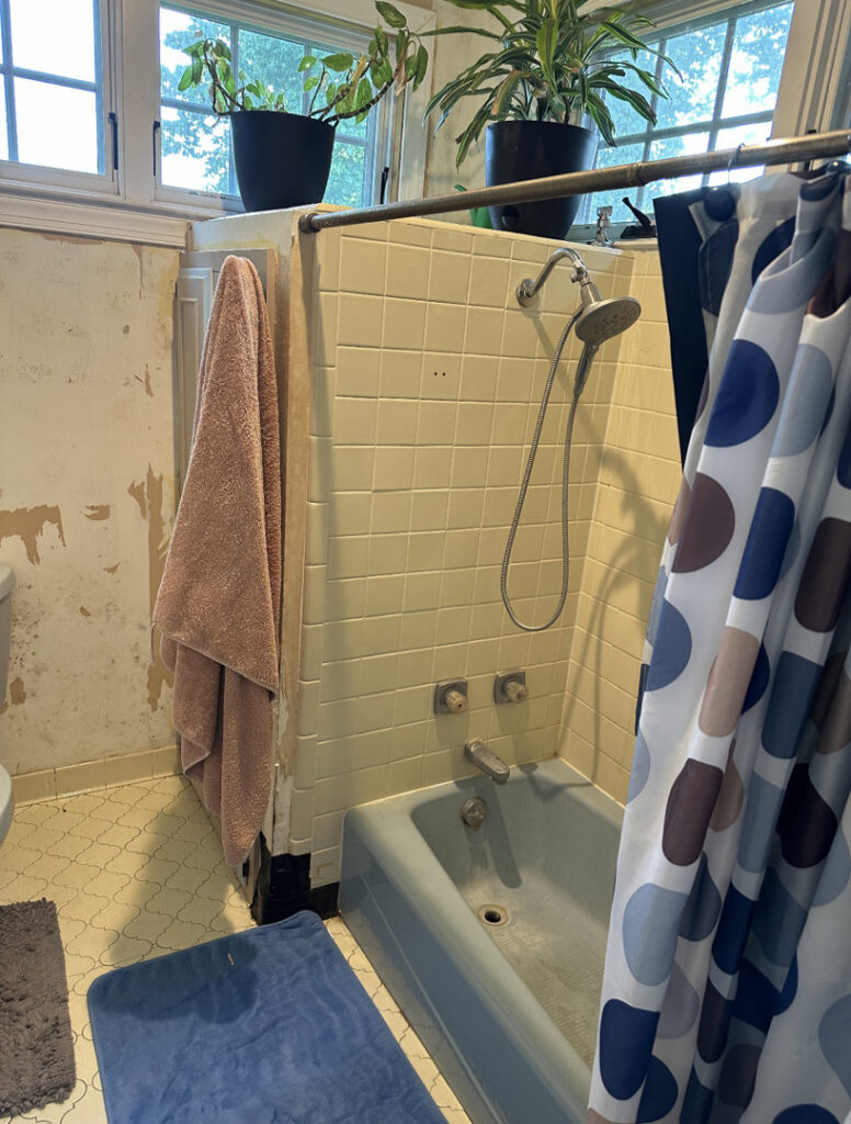 Bathroom demolition showing peeling wallpaper and old fixtures by KG Handyman & Remodeling in Vilonia, AR.